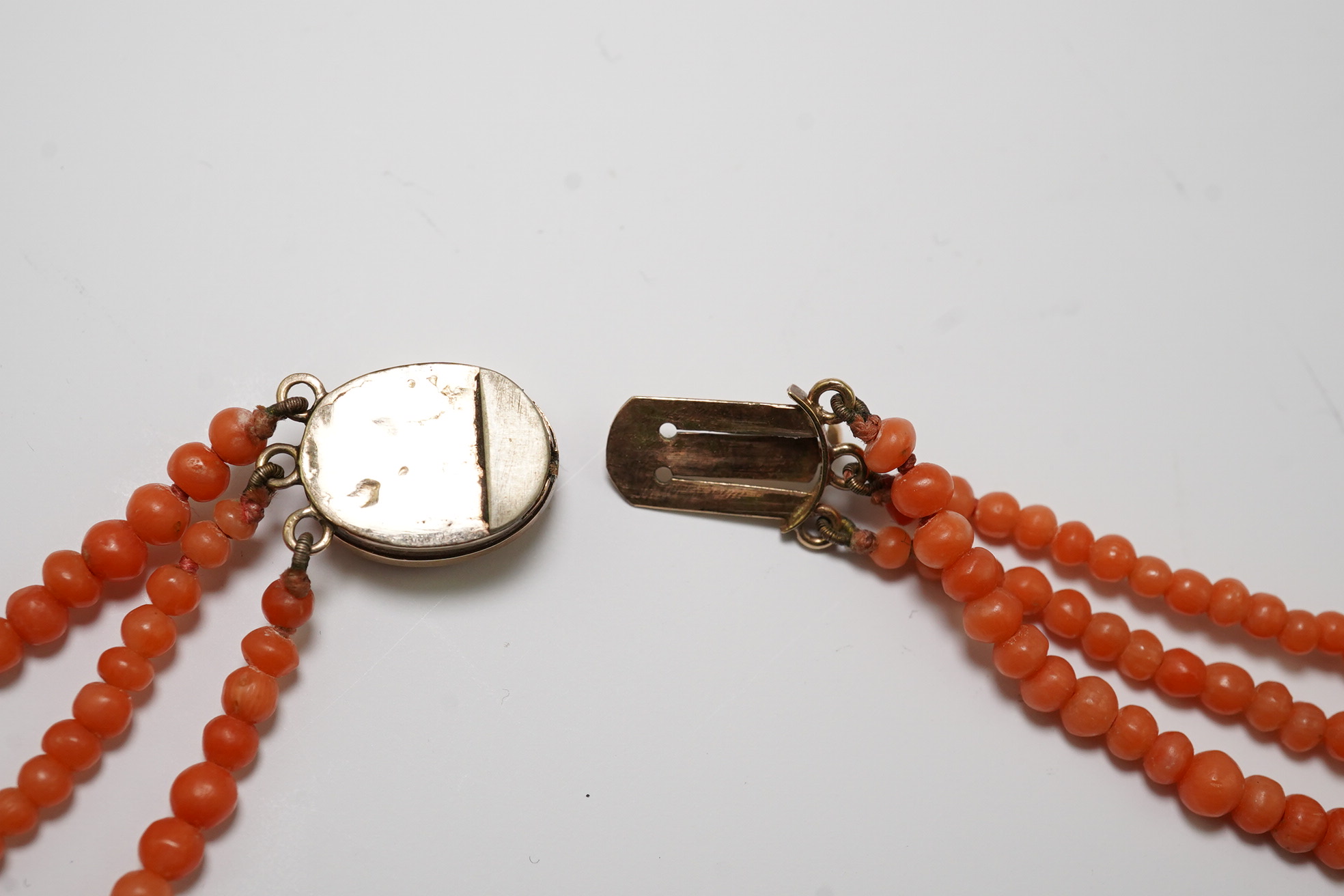 A late Victorian triple strand coral bead necklace